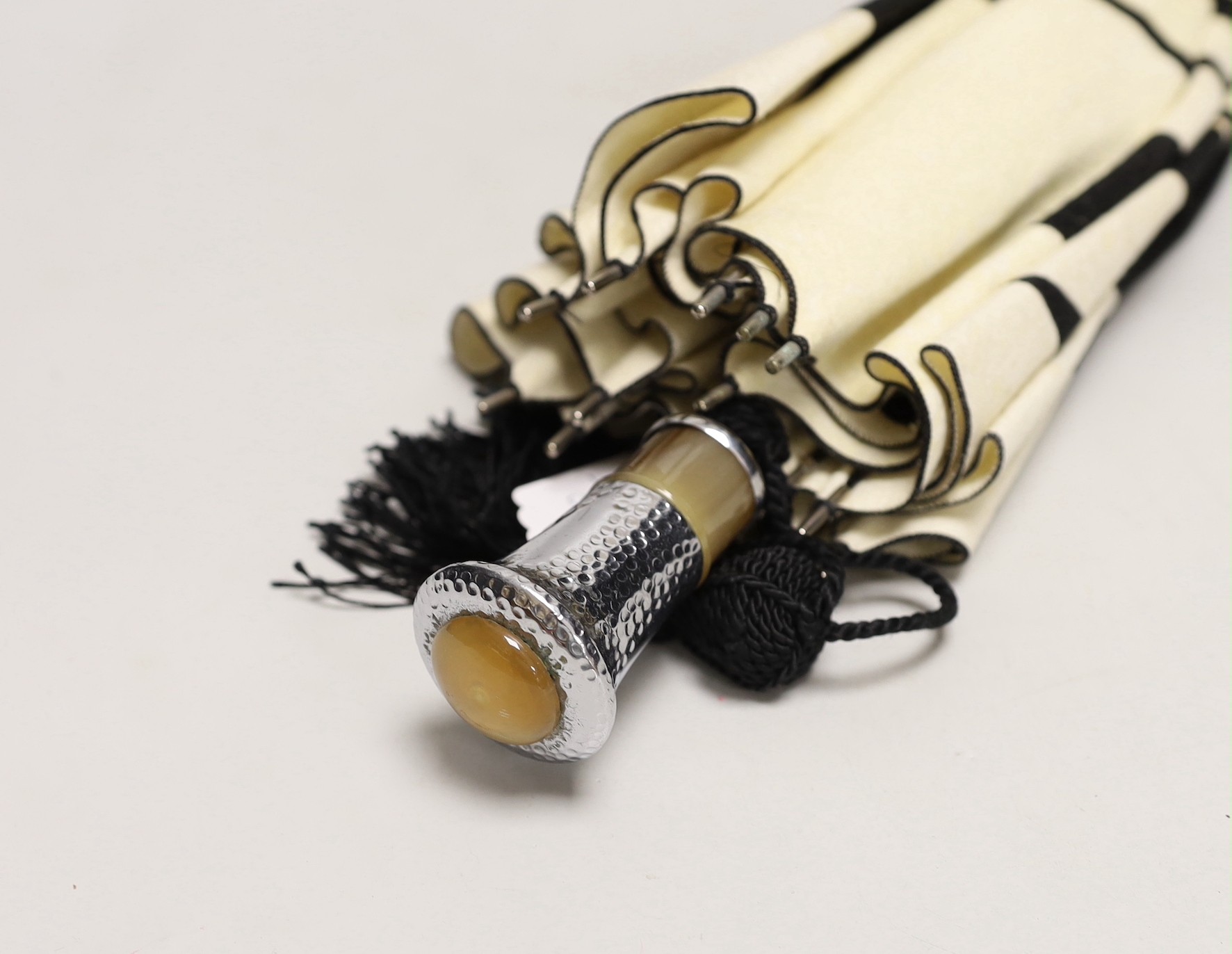 An unusual Japanese designed Art Deco cream and black felt parasol, with a horn and hammered metal handle